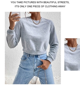 Detail of grey cropped sweatshirt with ribbed cuffs and trendy drop shoulder design