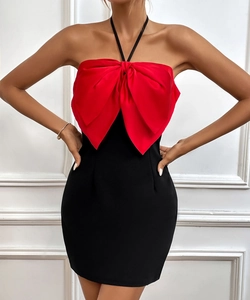 Detail of red satin bow and color-block design on elegant black halter evening dress