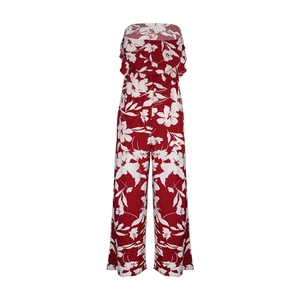 Detailed pattern of white flowers on red off-shoulder wide-leg jumpsuit fabric