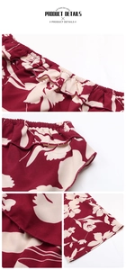 Close-up of ruffled hem and elastic waist on burgundy floral wide-leg jumpsuit