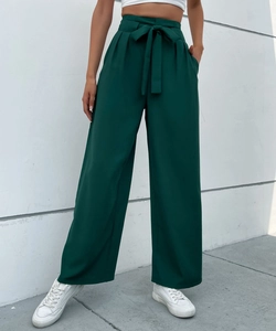Detailed view of high-waisted dark green wide-leg trousers with matching tie belt