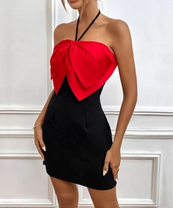 Detail of the oversized red 3D bow and halter-neck design on the slim mini dress