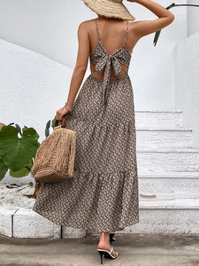 Back view of summer floral backless maxi dress with bow tie and tiered skirt hemline