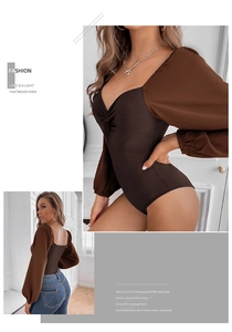 Detailed close-up of brown V-neck twist front bodysuit with contrasting puff sleeves
