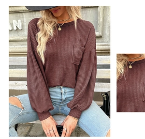 Close-up of wine red waffle knit texture and pocket detail on this long sleeve top