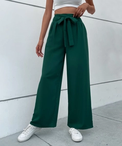 Detail of high-waisted dark green wide-leg trousers with elegant tied bow belt