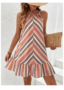 Detail of colorful striped halter dress with ruffled hem and bohemian vacation style