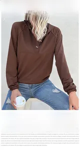 Detail of a brown hoodie with three-button Henley neck and elastic cuffs on sleeves