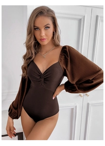Detail of V-neck knot twist design and puff sleeves on deep brown fitted bodysuit