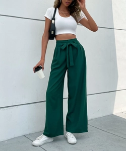 Detail of dark green high-waisted wide leg pants with an elegant fabric belt bow knot