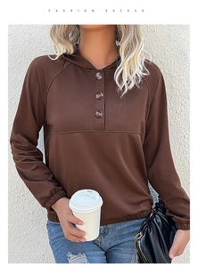 Close-up of brown hoodie showing button neckline, ribbed cuffs, and soft fabric texture