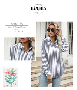 Detailed close-up of the classic collar and chest pocket on blue striped button-up shirt
