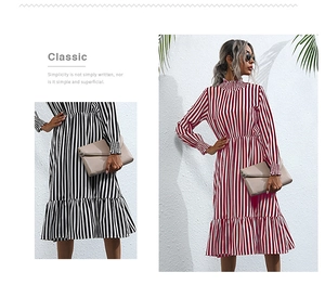 Close-up of vertical stripe texture and elegant ruffled hem on a long sleeve dress