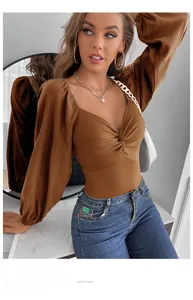 Detailed view of caramel long sleeve bodysuit with deep V-neck and twist knot front texture