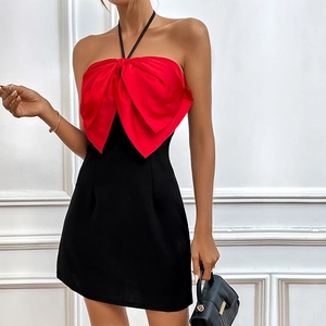 Women's halter neck dress with a large red satin bow and fitted black mini skirt
