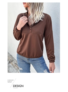 Detail view of brown long sleeve polo sweatshirt with button collar and elastic cuffs