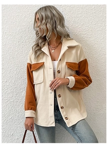 Close-up of contrast patchwork polar fleece texture on thick lapel shacket coat