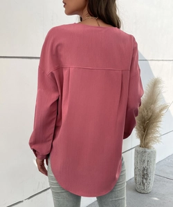 Back view of dark pink long sleeve shirt featuring drop shoulders and curved hem details