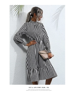 Detail of ruffle high neck and vertical stripes on a chic long-sleeved dress