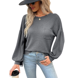 Chic dark grey waffle knit long sleeve top with crew neck and pocket on white background