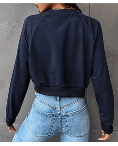 Rear view of cropped navy blue sweatshirt showing raglan sleeves and ribbed cuffs details
