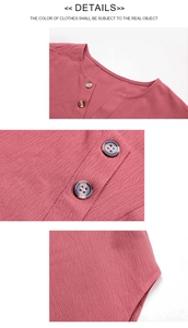 Detail of brick red long sleeve shirt featuring pleated fabric texture and amber buttons