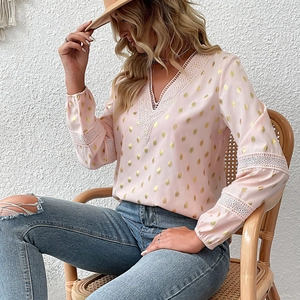 Pink long sleeve V-neck blouse with gold polka dots and lace trim details