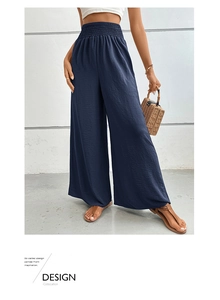 Detail of smocked high waist design on dark blue wide leg trousers for summer