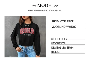 Detail of Brooklyn print and ribbed cuffs on black cropped fleece sweatshirt