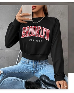Close-up of Brooklyn letter print on black cropped sweatshirt with round neck