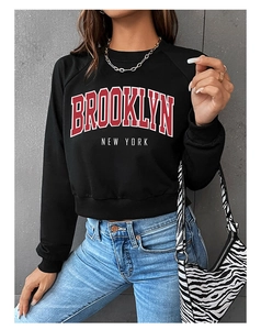 Detail of Brooklyn letter print on black cropped sweatshirt with high-quality fabric texture