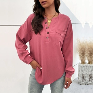 Pink long sleeve henley shirt for women with buttons and front pocket on white background
