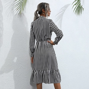 Vertical striped long sleeve midi dress with turtleneck and ruffled hem in black and white