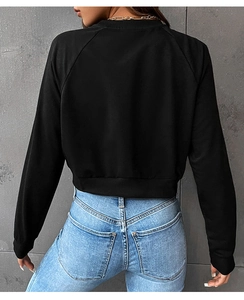 Back view of cropped black sweatshirt with fine knit texture and modern fit detail