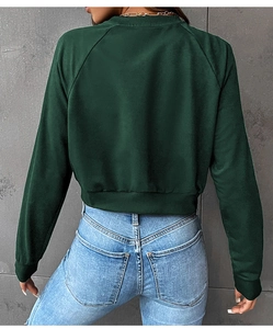 Rear view of cropped dark green raglan sweatshirt and light blue high-waisted jeans