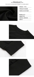 Detail view of the black cropped sweatshirt showing collar texture and ribbed cuffs