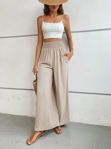 Detail of high waist wide leg pants with elastic waistband and lace trim camisole