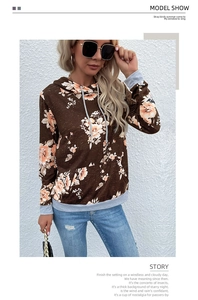 Detail of floral print hoodie with kangaroo pocket and ribbed cuffs in a street style look
