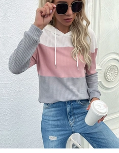 Detail of waffle knit fabric on striped colorblock hooded sweater with drawstring