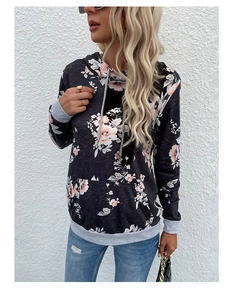 Close-up of floral print patterns and contrast drawstring detail on hoodie