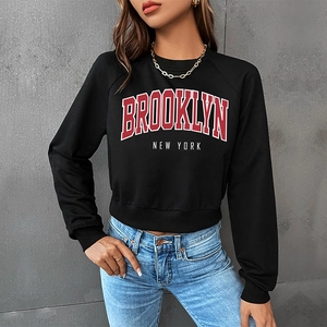 Women's black cropped crewneck sweatshirt with Brooklyn New York graphic print