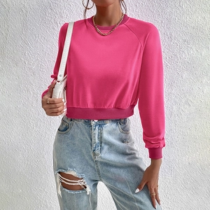 Vibrant pink cropped crewneck sweatshirt with raglan sleeves and ribbed knit details