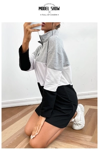 Detail of three-color patchwork long sleeve sweater dress with quarter zip high collar