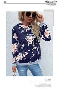 Detail view of floral print hoodie with grey ribbed cuffs and drawstring on navy base