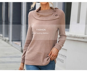 Detail of dusty pink ribbed knit sweater with unique asymmetrical collar and buttons