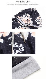 Detail eines Blumen-Hoodies mit grau gewebten Kordeln und hochwertigen Metallspitzen