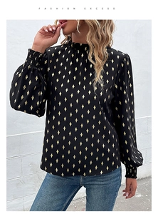 Detail of the ruffle high neck and gold geometric pattern on this long sleeve black blouse