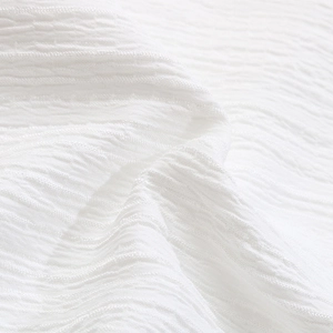 Close-up of white seersucker fabric texture with horizontal crinkle wave patterns