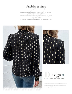 Detail of ruffled high collar and gold rhombus pattern on black long sleeve shirt