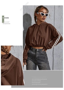 Detail view of cropped brown drawstring hoodie with white side stripes and elastic hem